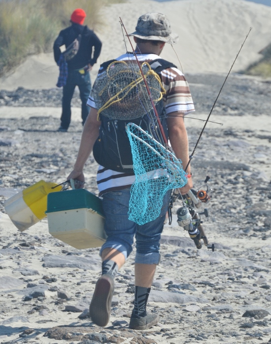 a fisherman leaves the south jetty